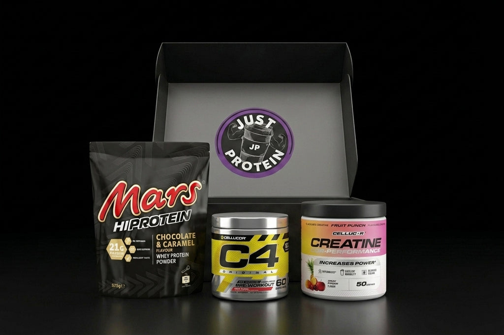 A curated supplement bundle featuring a black bag of Mars Hiprotein, a silver canister of C4 Protein, and a white tub of Creatine by Pulse Nutrition, arranged in front of an open black gift box with a purple 'Just Up Protein' logo on a black background.